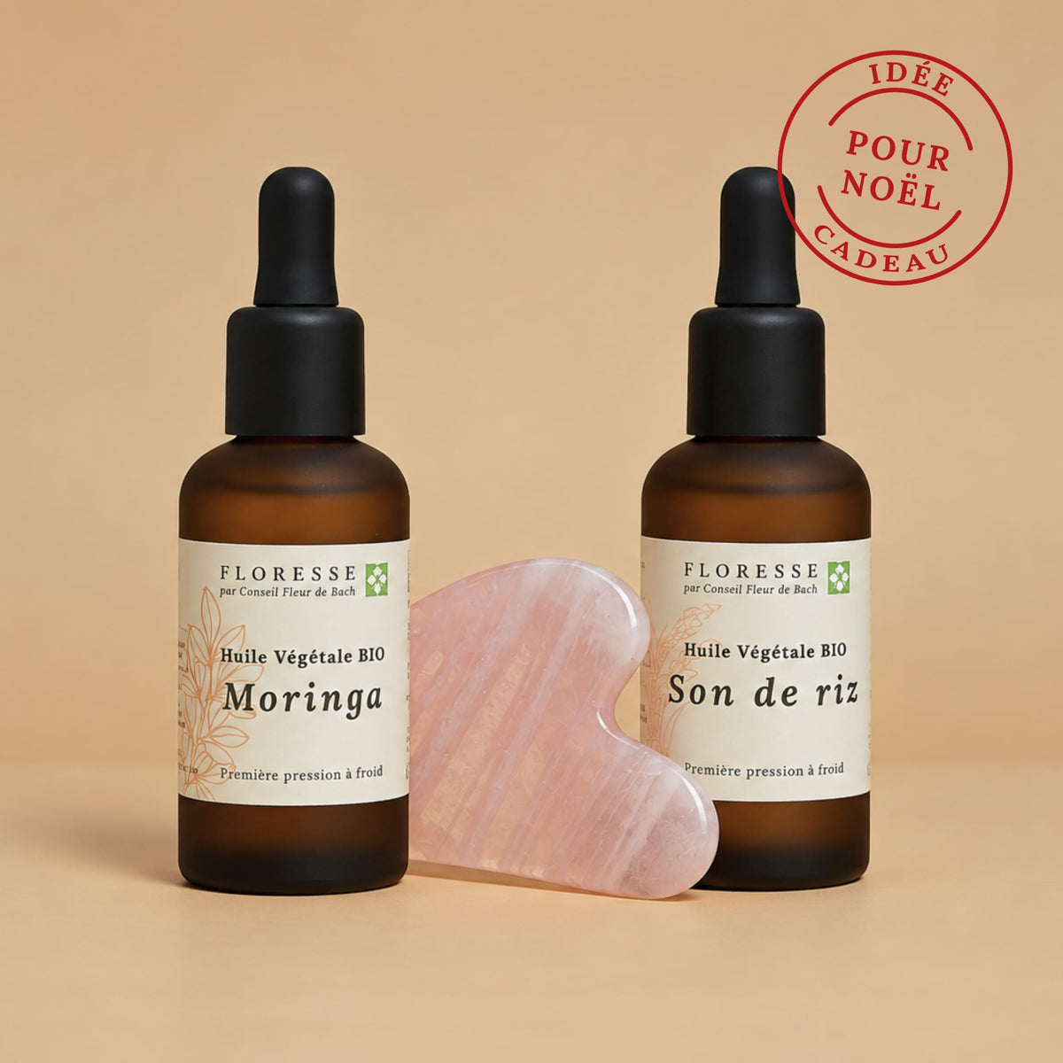 Outil de massage Gua Sha accompagné de son duo d'huiles végétales pour le visage.