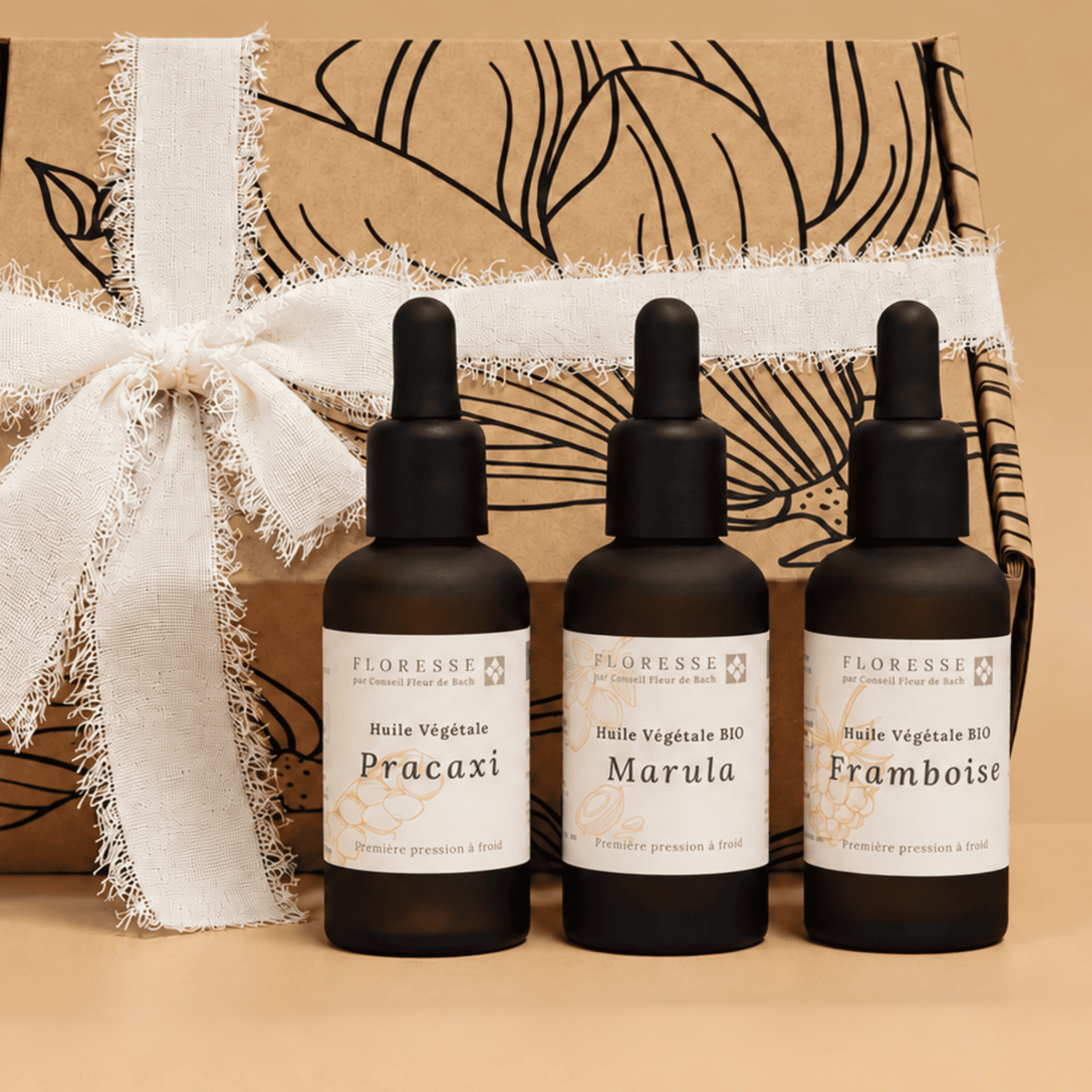 Trio d'huiles végétales d'exception présentées dans leur coffret cadeau.