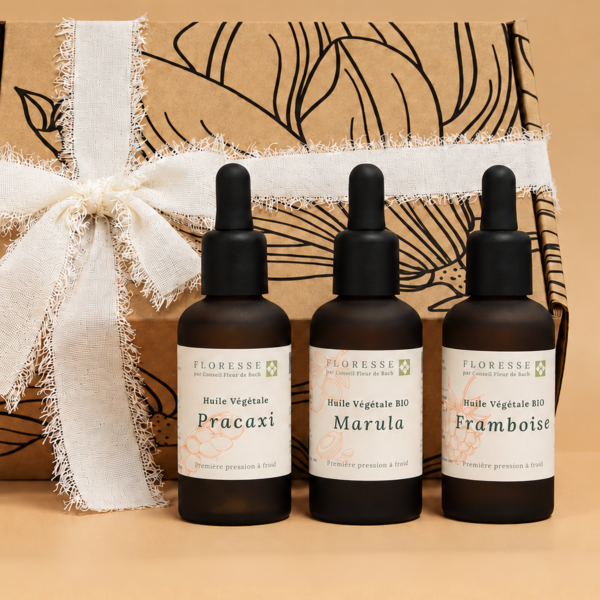 Trio d'huiles végétales d'exception présentées dans leur coffret cadeau.